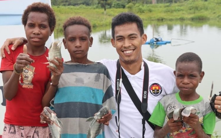 Bripka Ibrahim bersama bocah-bocah Papua. (Ist)