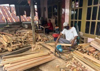 Gunanto (kiri) bersama seorang karyawan sedang memproduksi produk mebel. (doc. IM/PortalBalikpapan)